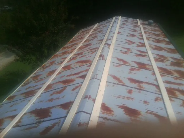 Rusted metal roof panels with new wood purlins before replacement — Storm Damage Roof Repair in New Paltz by Roofing Brothers
