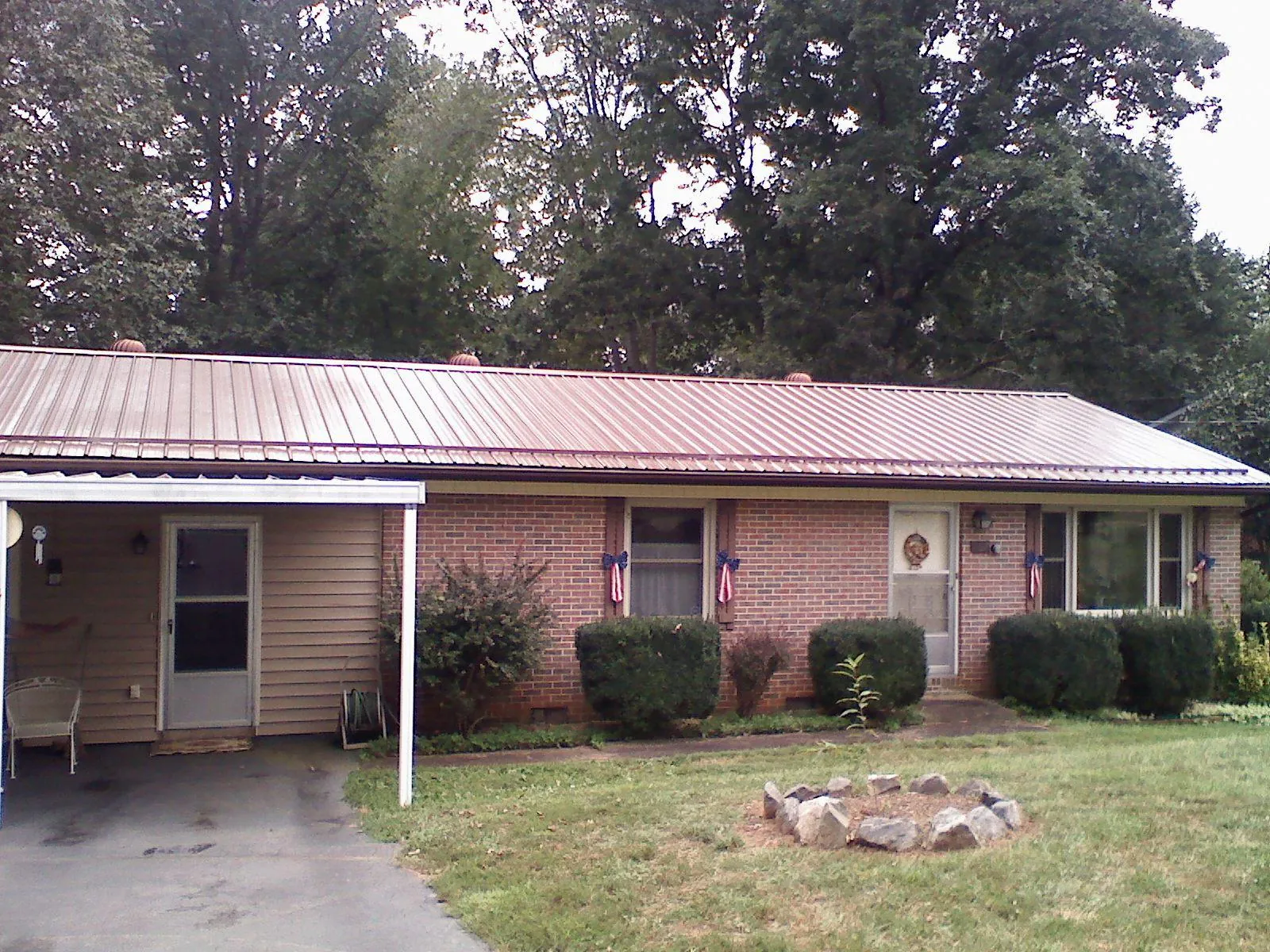 Bronze metal roof and carport on a brick ranch home — Roof Repair work by our crew in New Paltz