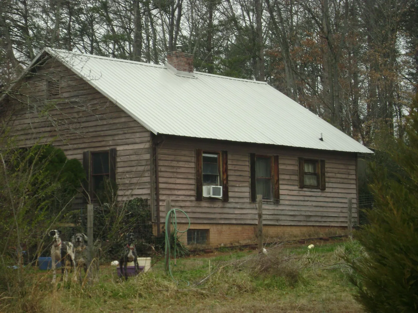 White metal roof on an old wood sided farmhouse, from a Metal Roof Installation job in New Paltz